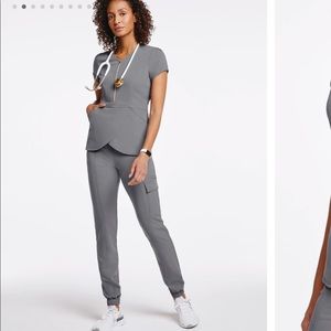 This tulip scrub top with standout gold hardware is very cute!